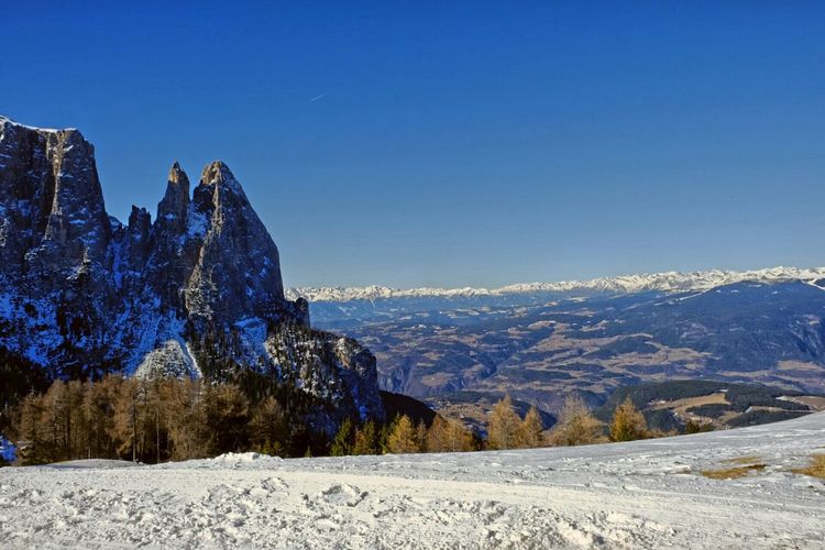 Scenic view of mountains against clear blue sky