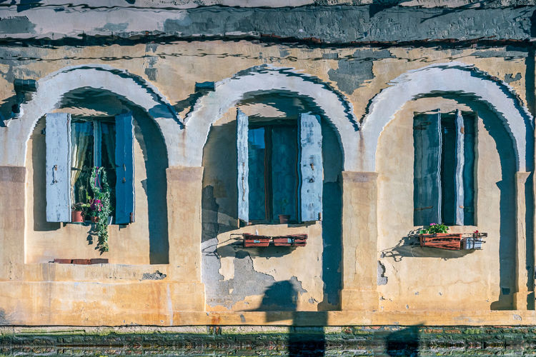 Reflection of  wall of windows of old building on the water of a canal