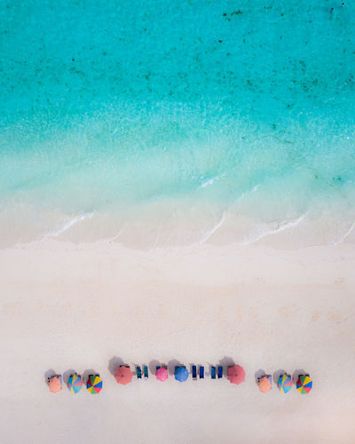 HIGH ANGLE VIEW OF TEXT WRITTEN ON BEACH