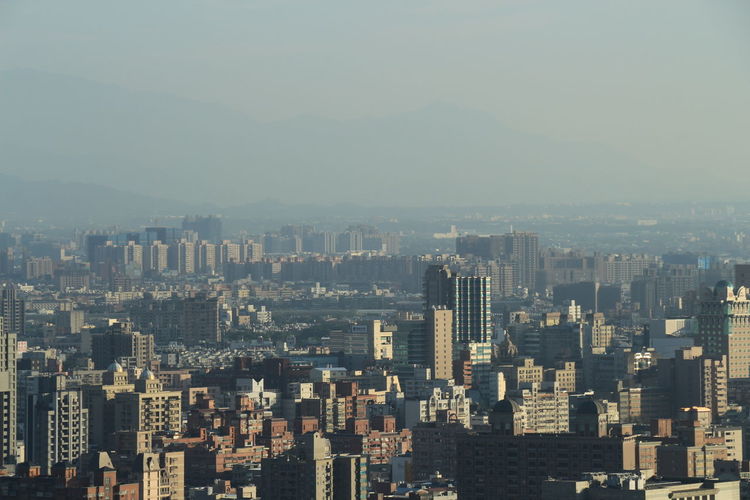 Aerial view of modern buildings in city against sky