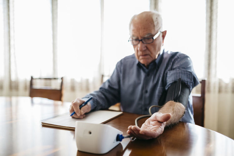 Portrait of man using digital tablet in office