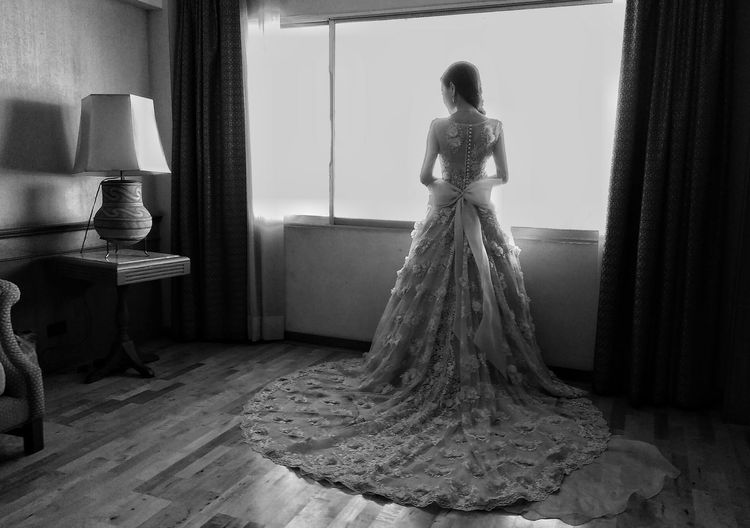 Rear view of woman standing at home