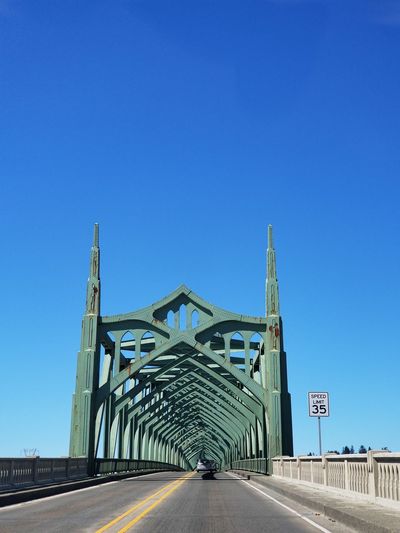 View of coos bay bridge against blue sky.