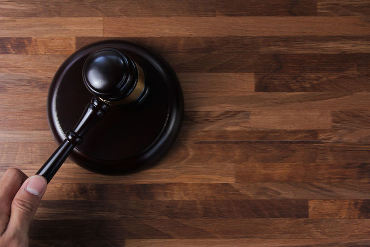 High angle view of hand on wooden table
