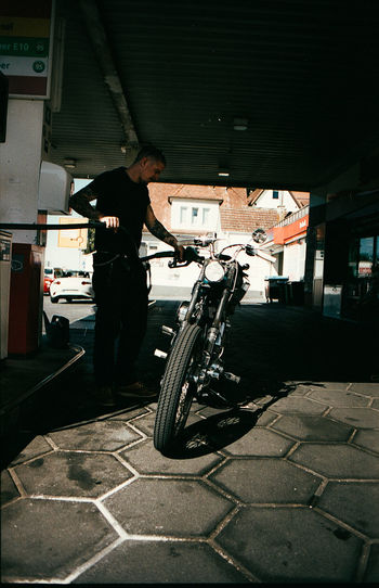 Man with a motorcycle at the gas station 