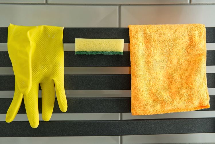 Basic house cleaning equipment - rubber glove, microfiber cloth and a sponge
