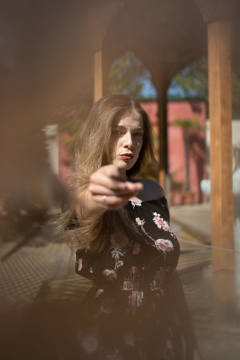 Young woman with arms raised