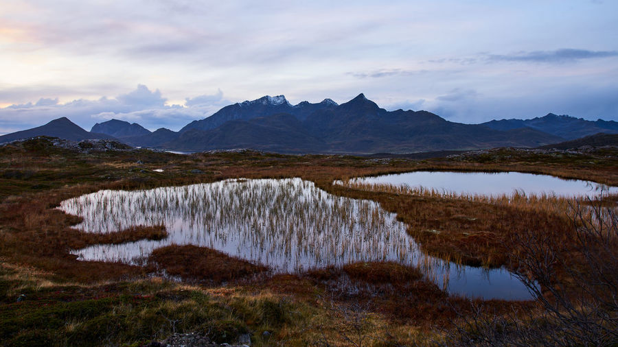 Scenic view of lake and mountains against sky