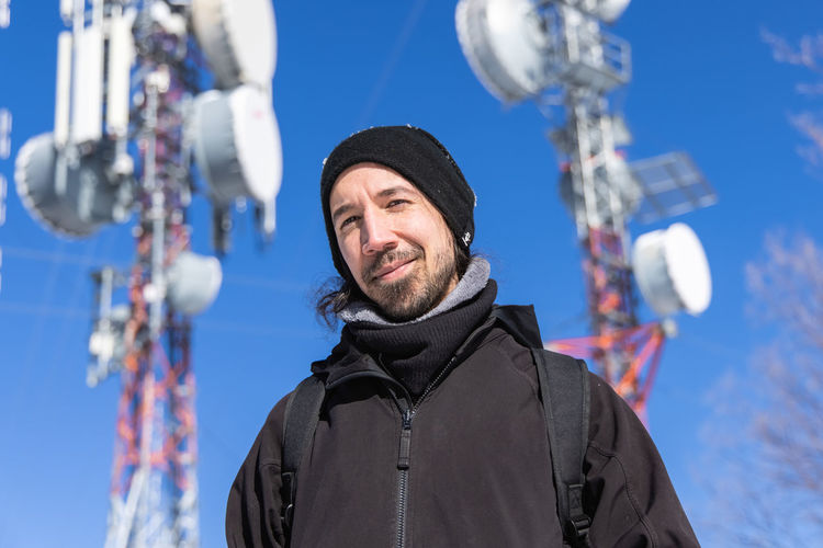 Portrait of smiling man against sky during winter