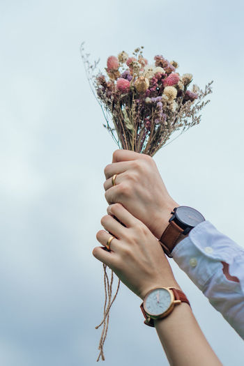 Close-up of hand holding bouquet of flower