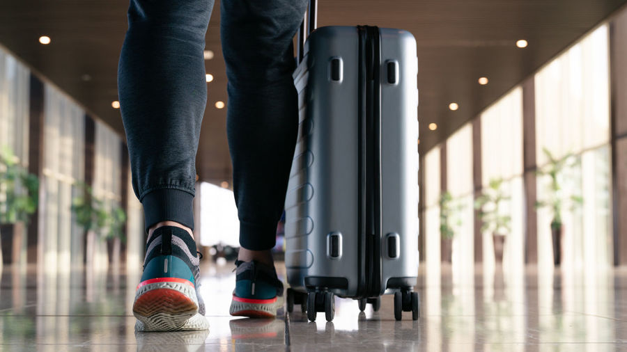 Traveler with suitcase walking with carrying luggage and passeng