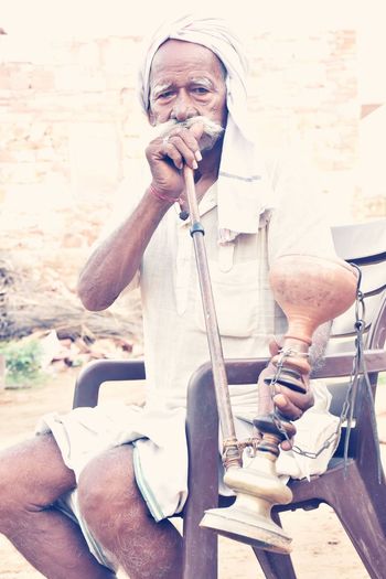 Portrait of man smoking hookah