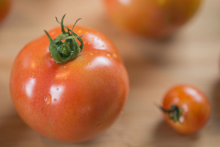 Close-up of wet cherry tomatoes on table