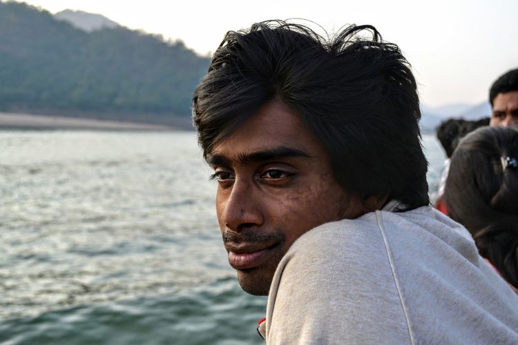 Portrait of young man looking away outdoors