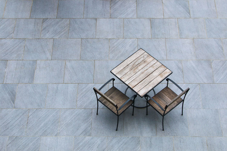 High angle view of chairs and table on floor