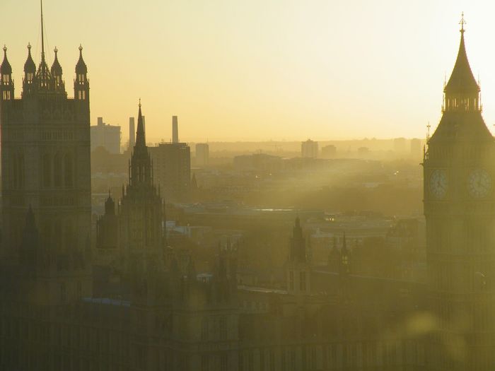 House of parliament against sky during sunrise