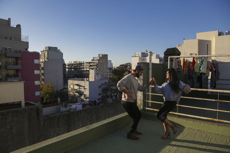 Couple dancing in a roof top in buenos aires 