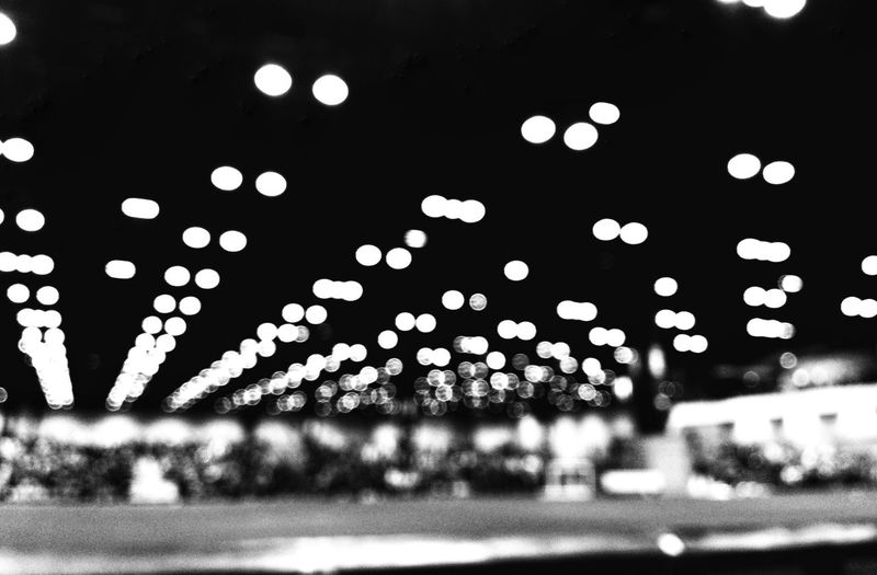 Defocused image of illuminated city street at night