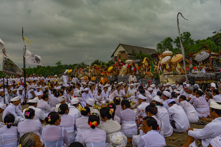 Group of people in traditional clothing against sky