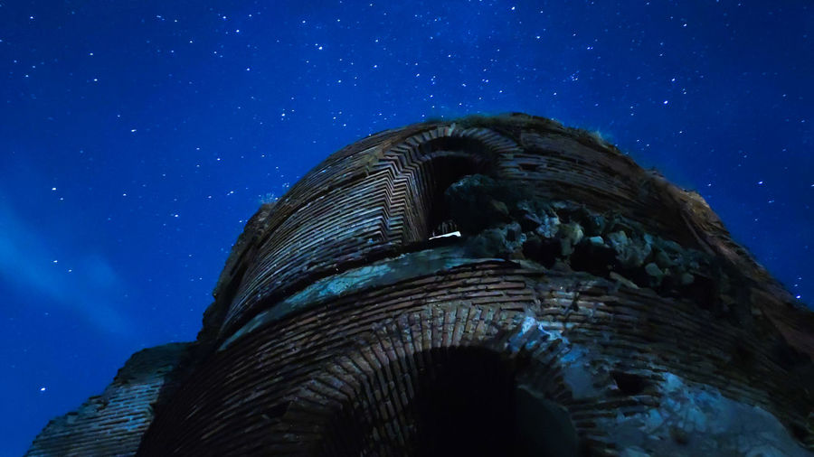 Low angle view of an old church ruin from the 5th century and the night sky 