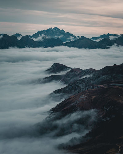 Scenic view of cloudscape against mountains during sunset