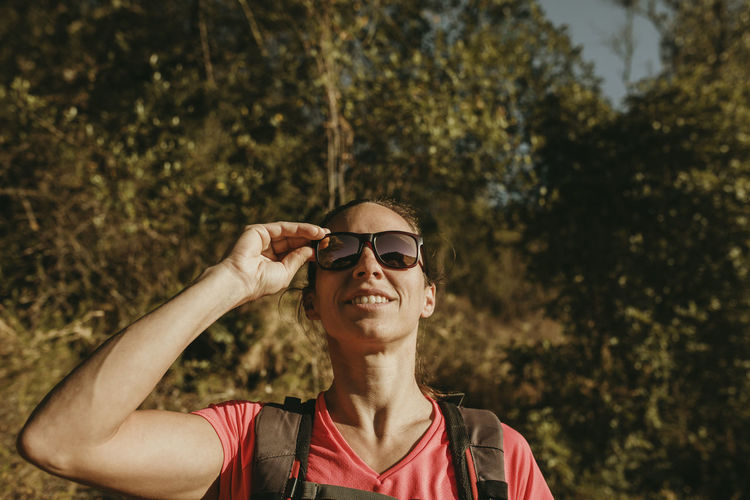 Portrait of man wearing sunglasses against trees