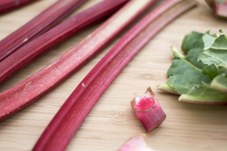 Close-up of rhubarbs on wooden table