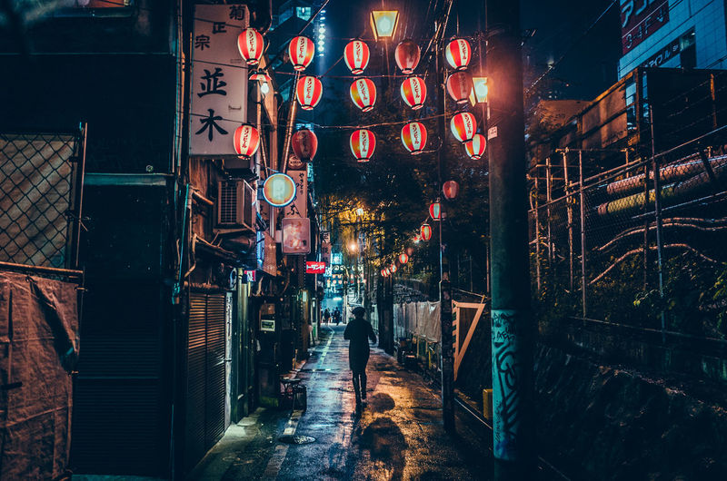 Illuminated lanterns hanging in city at night