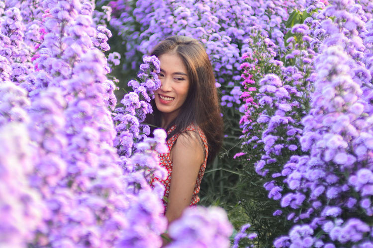 Portrait of a beautiful young woman with purple flowers