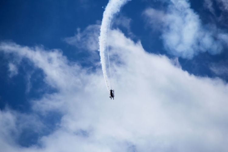 Low angle view of airplane flying against sky