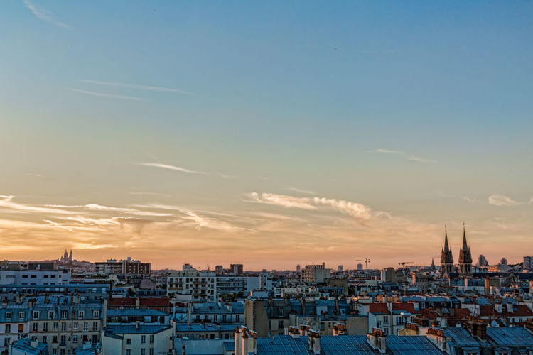 Scenic view of residential district against sky during sunset
