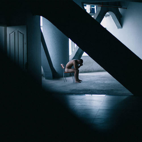 Woman sitting in corridor