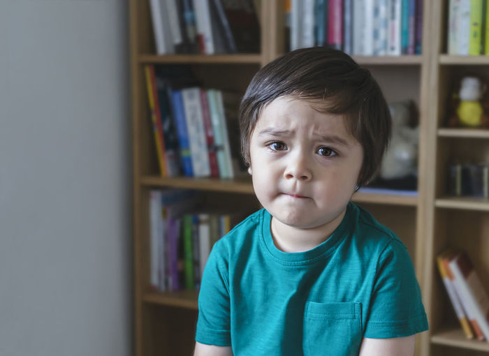 Portrait of boy sitting at home