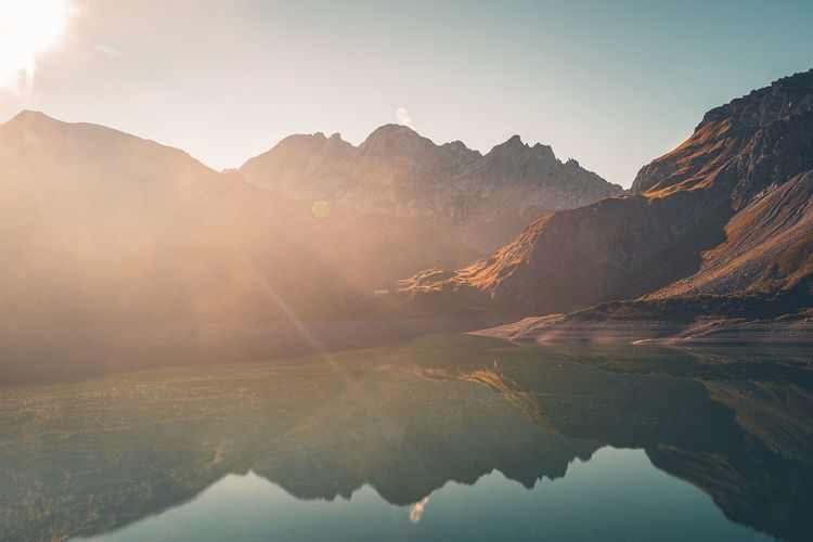 Scenic view of lake and mountains against sky