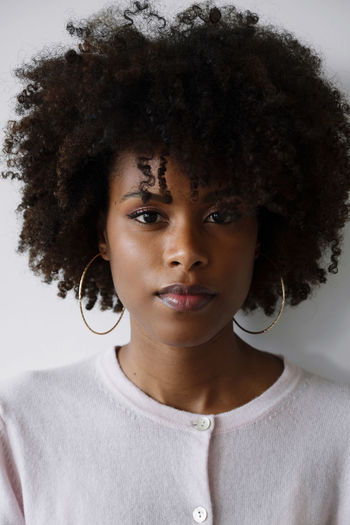 Portrait of a beautiful black woman with afro on the white background
