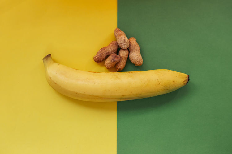 Close-up of bananas on table against yellow background