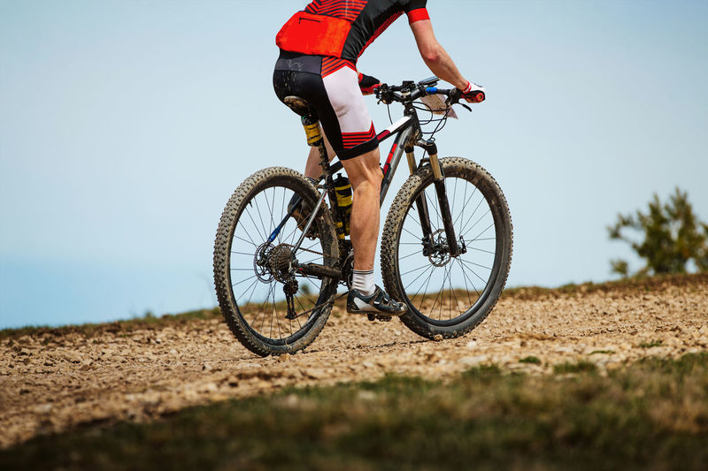 Male cyclist riding mountain bike uphill