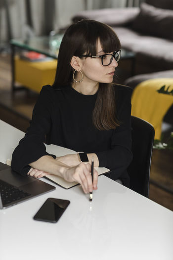 YOUNG WOMAN USING MOBILE PHONE