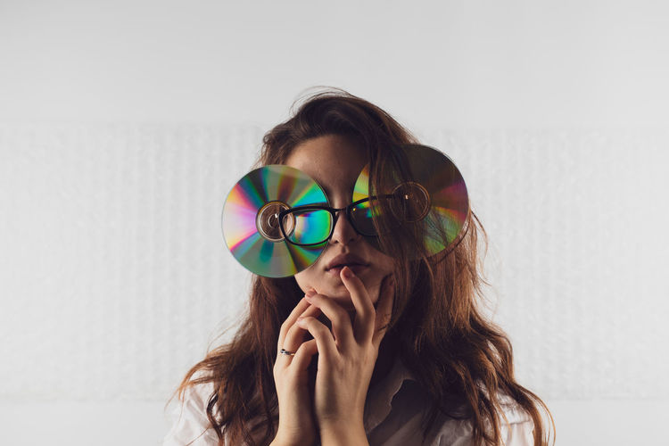 Woman wearing eyeglasses with compact discs