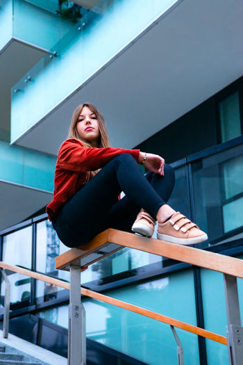 Low angle view of woman sitting on staircase