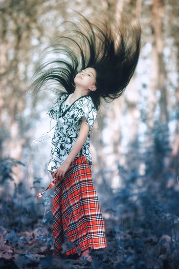 Full length of woman standing on land in forest