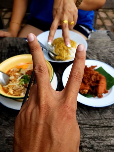 Midsection of people holding food