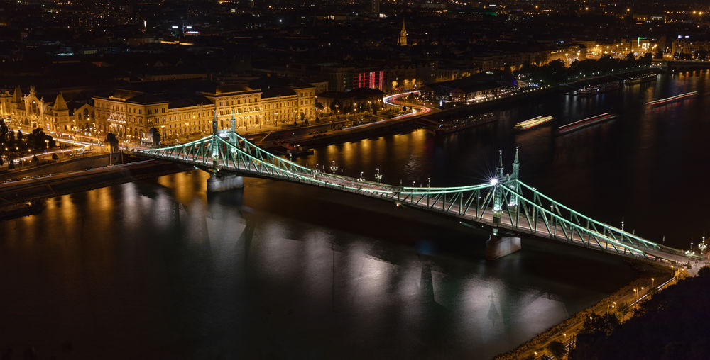 High angle view of liberty bridge over danube river in city at night