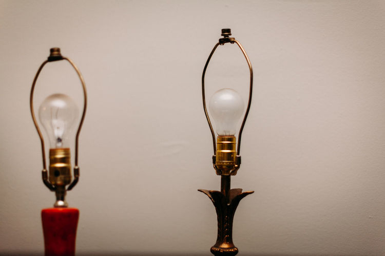 Two lamps side by side with bare bulbs.