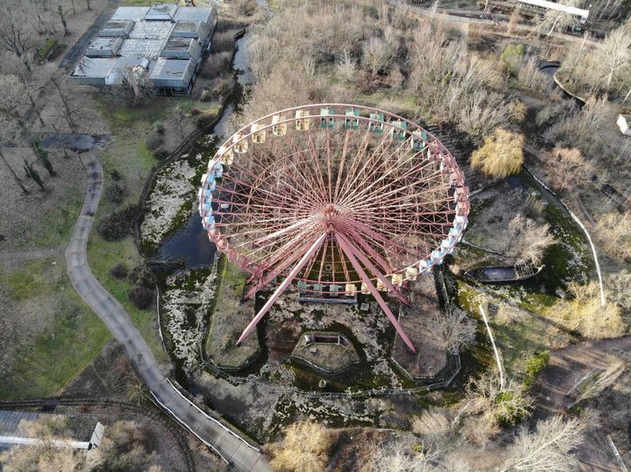 High angle view of ferris wheel by building in city