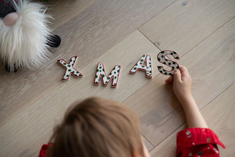 High angle view of girl playing with toys on table