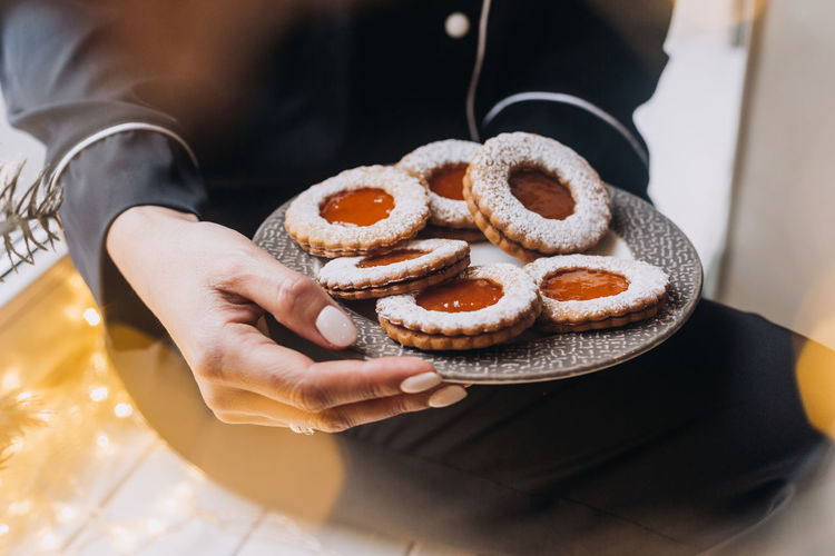 Midsection of woman holding cookies