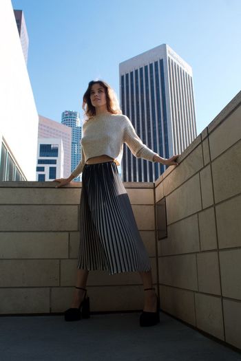 Rear view of woman standing against building