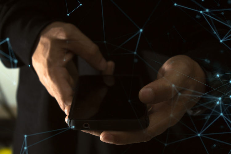Midsection of person using mobile phone
