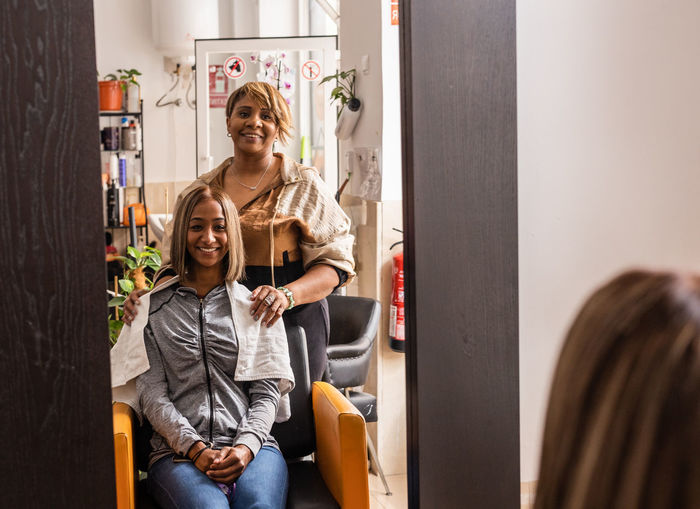 Hair dresser with customer in salon